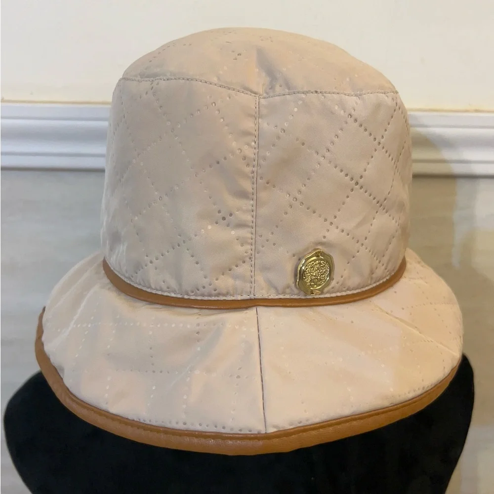 Vince Camuto Quilted Cream Bucket Hat with Tan Trim and Gold Emblem